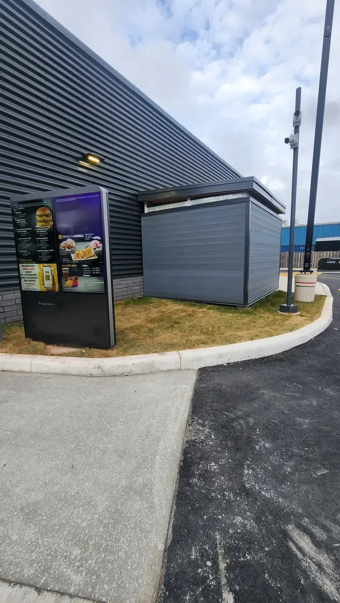 Drive-thru restaurant waste enclosure showing architectural integration with building