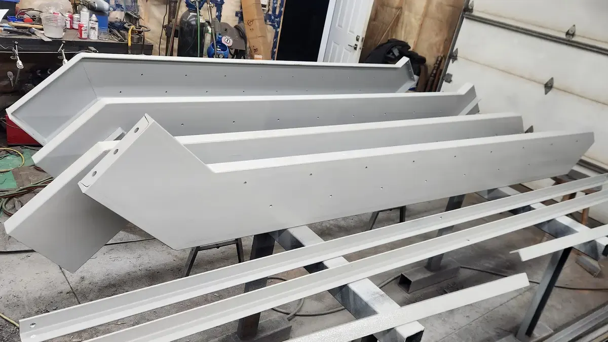 Detail view of painted steel channel brackets showing welded connections