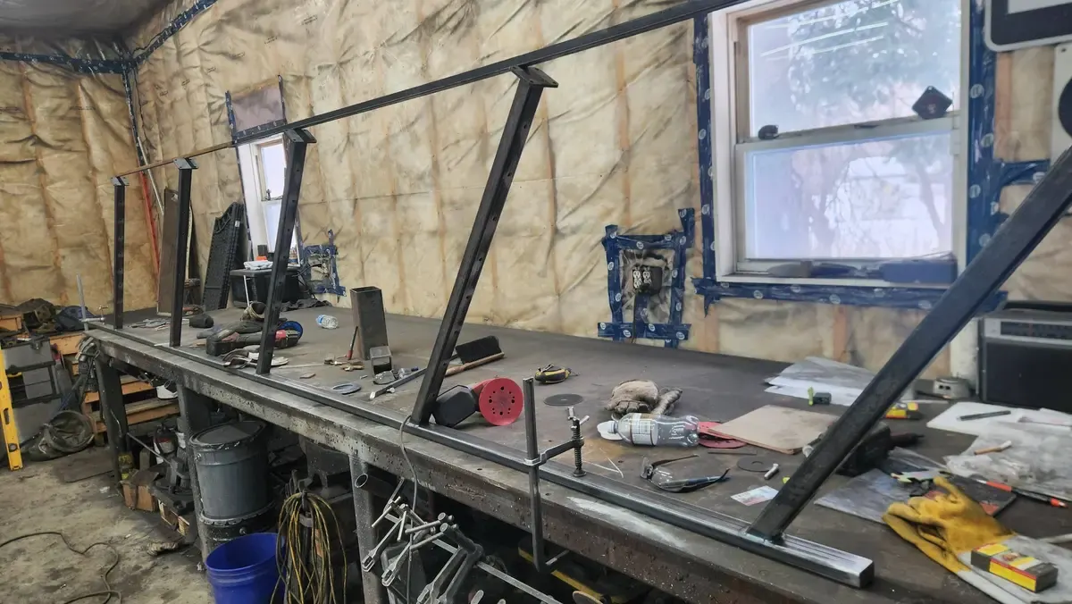 Multiple railing frames on welding bench showing batch fabrication process