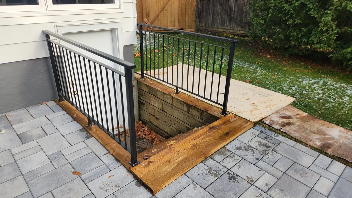 Close-up of cellar hatch safety railing with vertical bars on residential patio