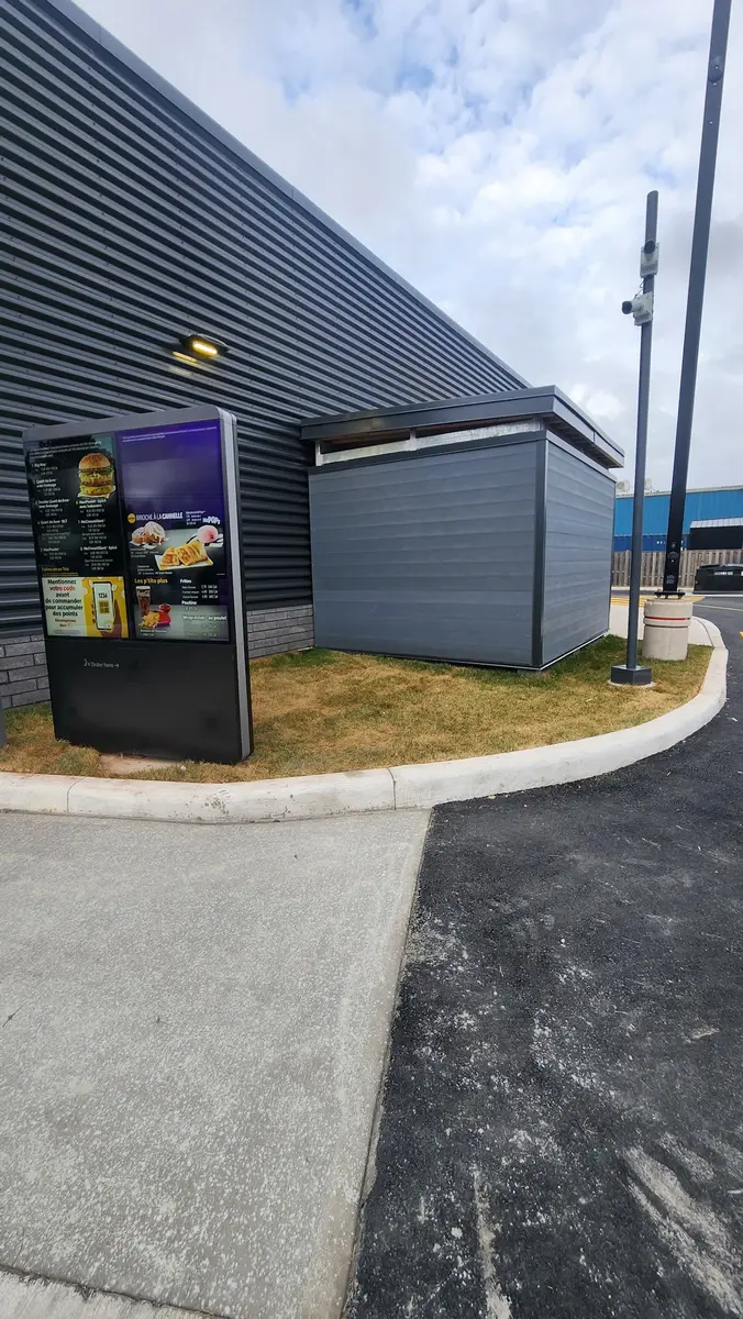Drive-thru restaurant waste enclosure showing architectural integration with building