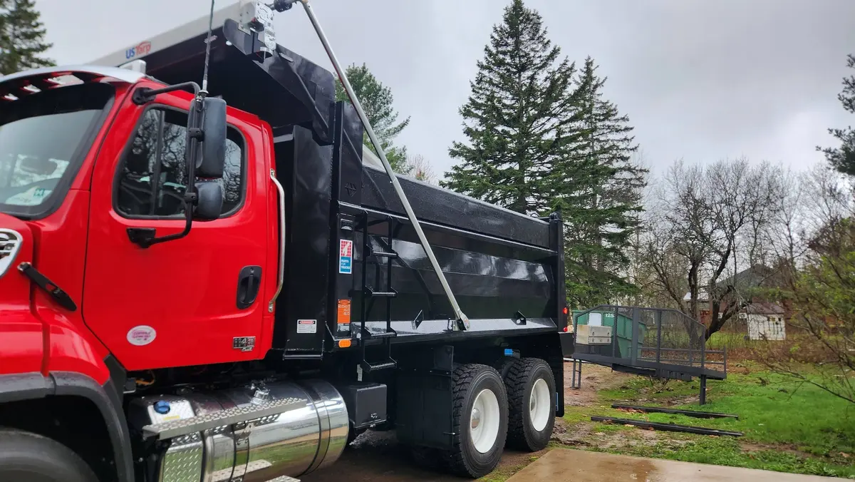 Complete custom dump truck box mounted on red Freightliner cab chassis