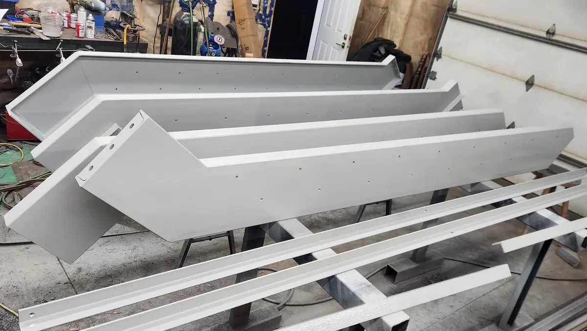 Detail view of painted steel channel brackets showing welded connections