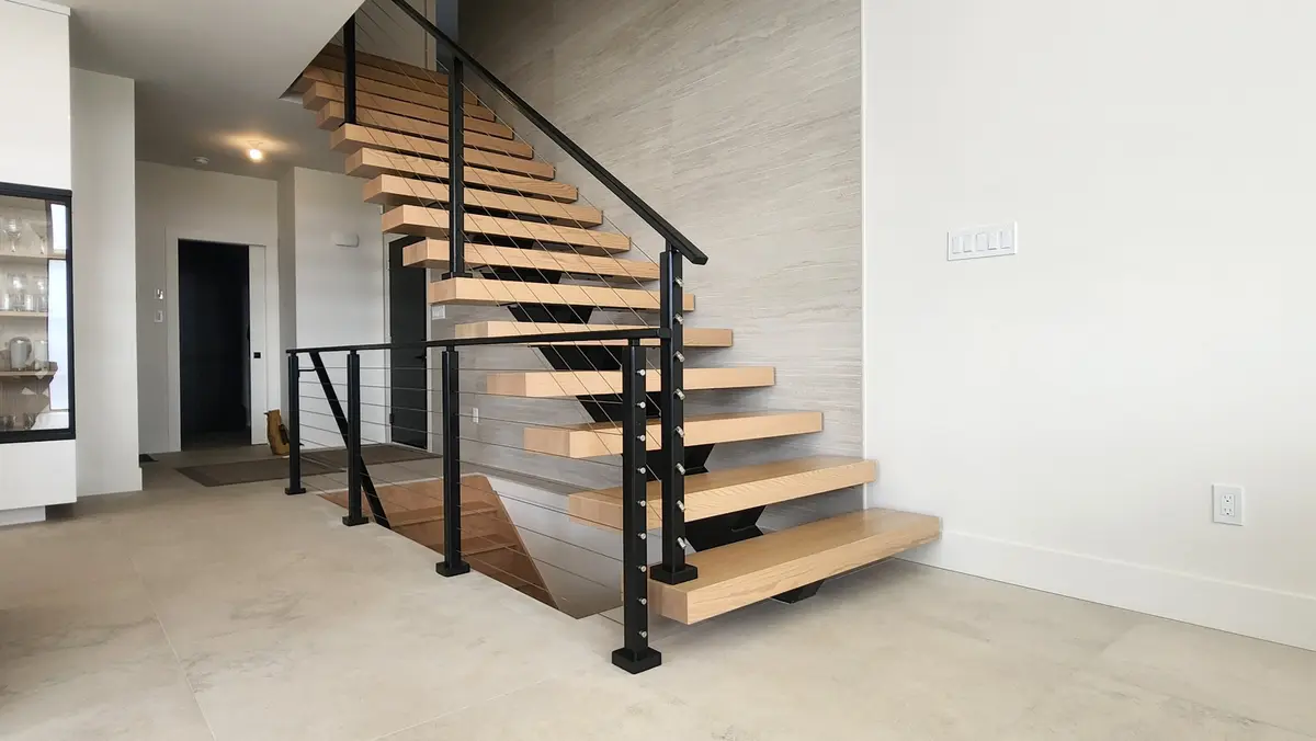 Custom floating staircase with cable railing and oak treads in luxury home
