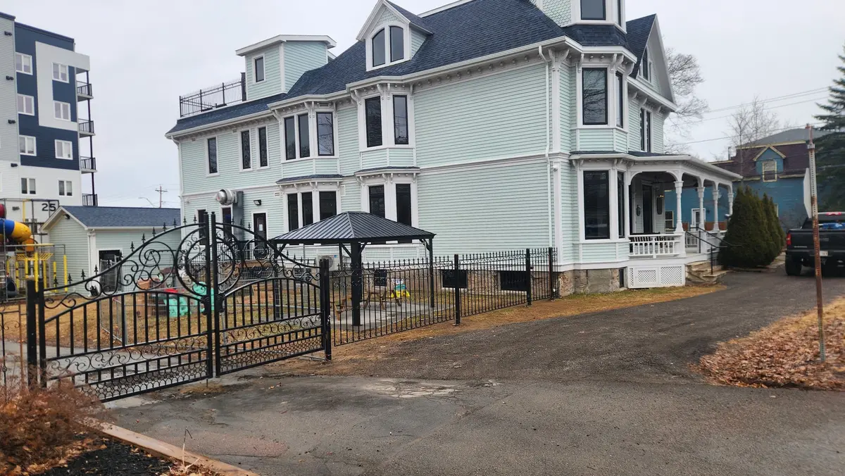 Ornamental iron driveway gate and fence at heritage Victorian property with gazebo