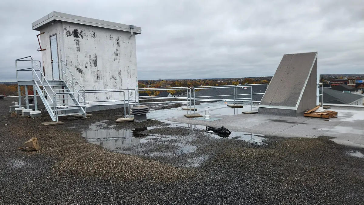 Wide view of rooftop access stairs and equipment platform on commercial building